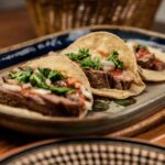 Goat barbacoa tacos with onion, cilantro, and lime