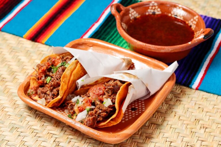 Goat birria tacos with a cup of consomme