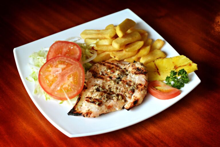 Juicy grilled chicken breast with grill marks served with fresh sides