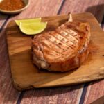 Pork chop on a wooden board