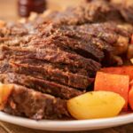 Porcini and red wine beef pot roast with carrots and potatoes on a plate