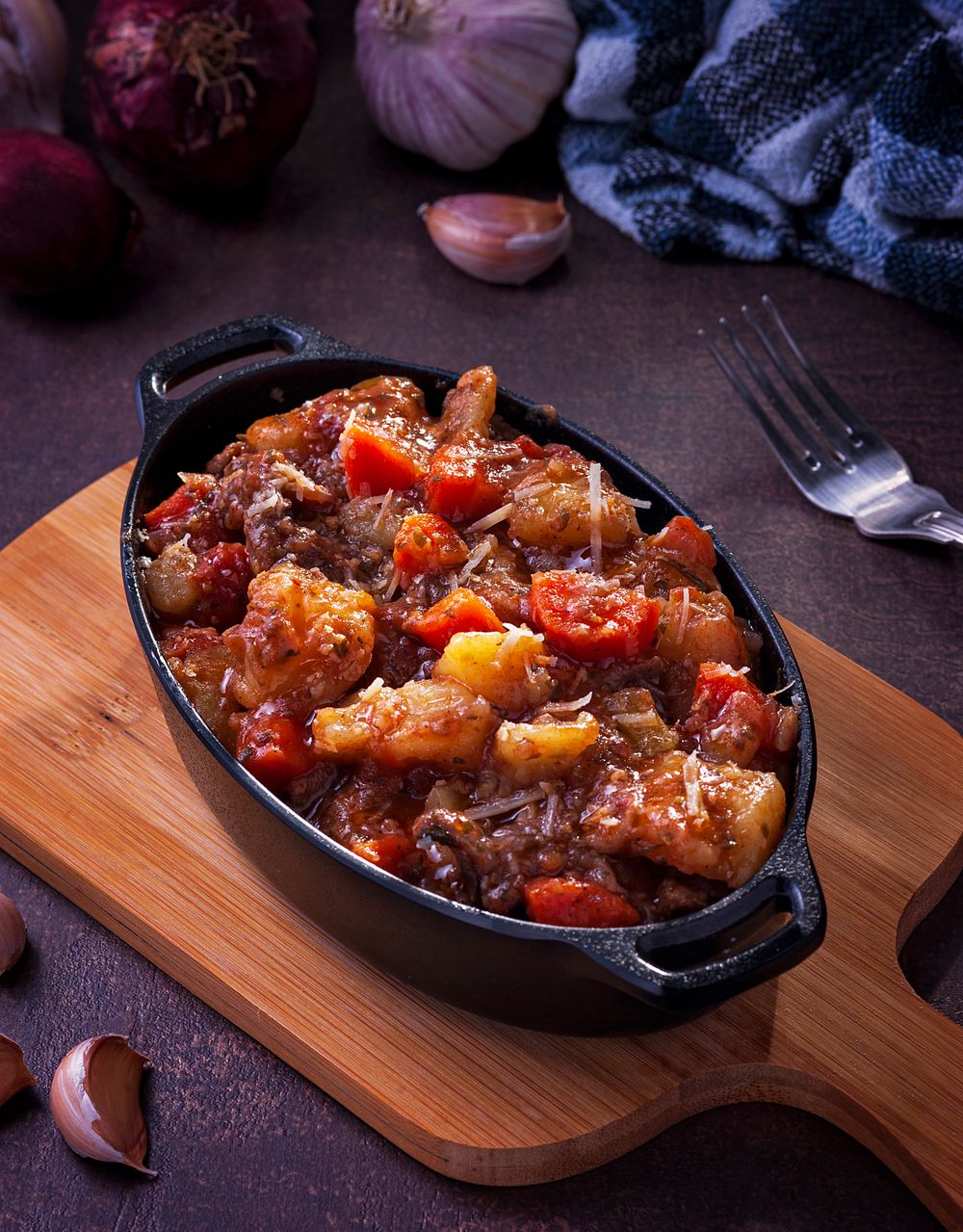 Beef chuck roast braising with vegetables in a black cast iron Dutch oven