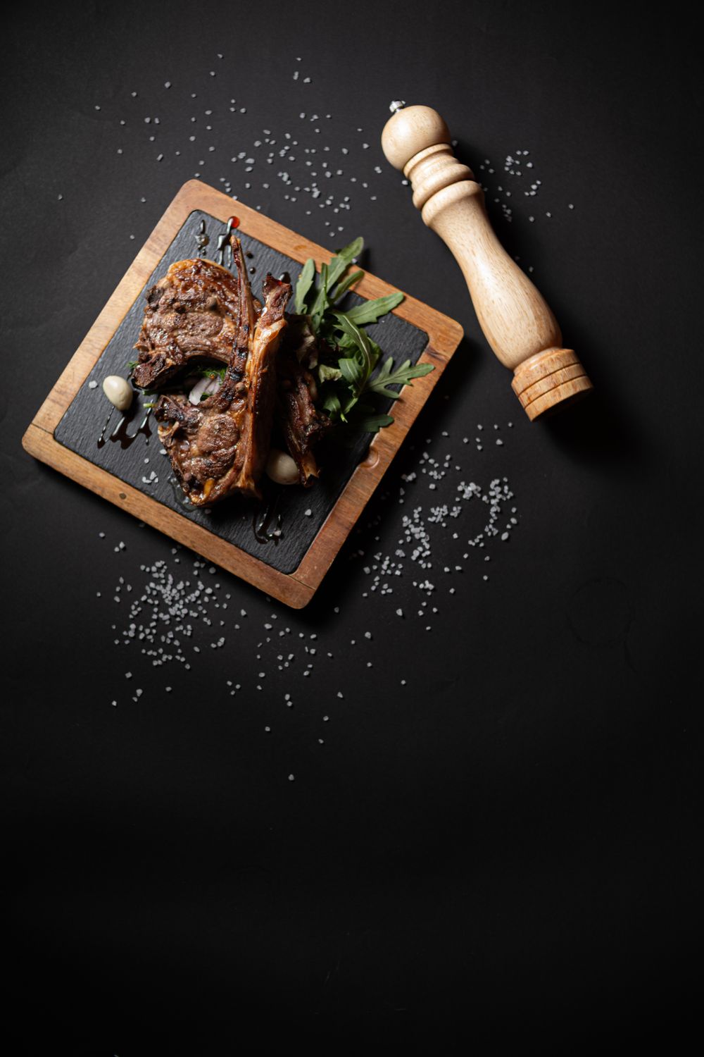 Browned slow-roasted goat leg resting on the table before carving