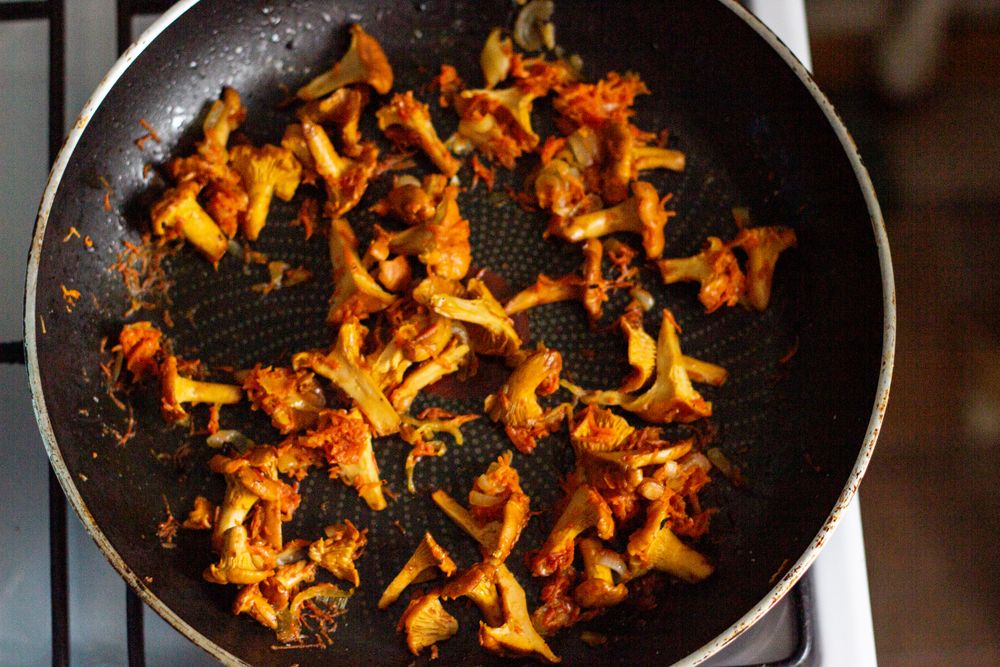 Wild chanterelle mushrooms sauteing in a skillet until browned for Chicken Marsala