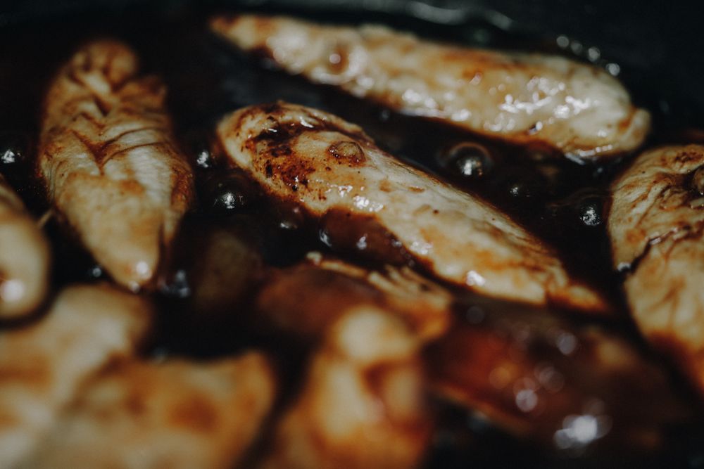 Chicken cutlets searing to golden brown in a hot skillet for Chicken Marsala