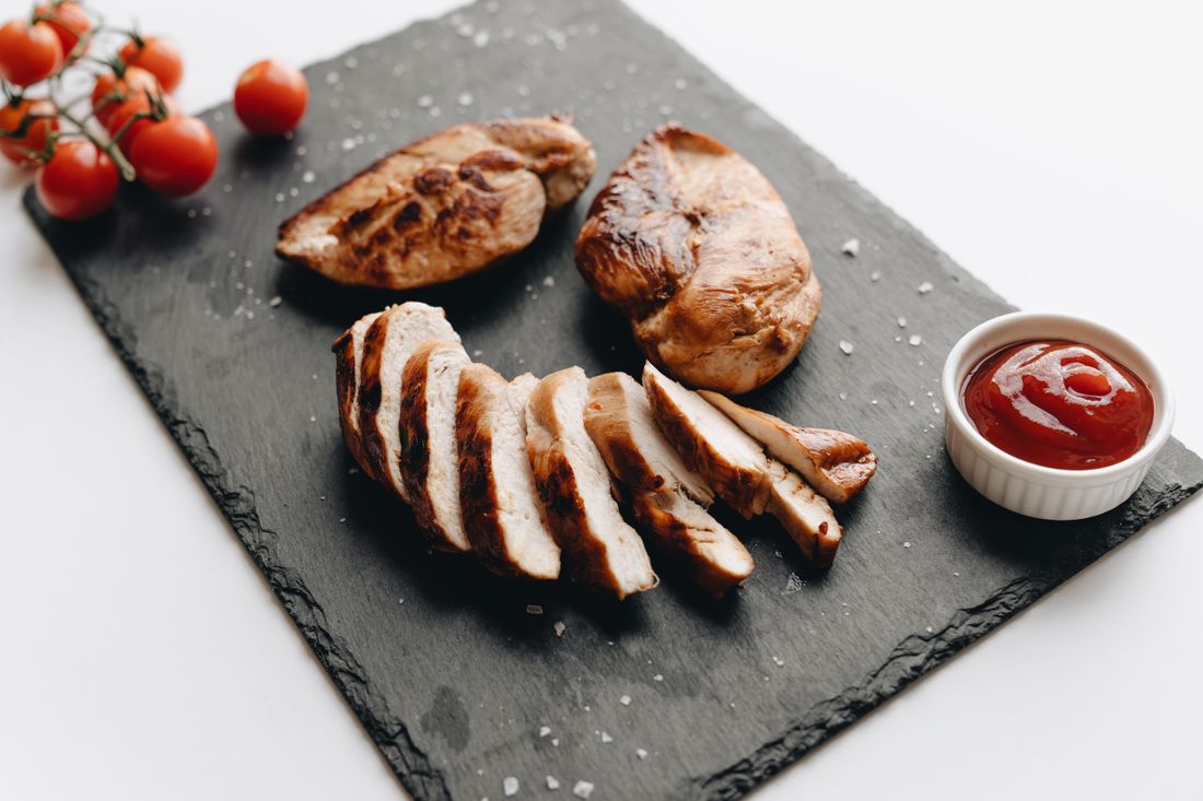 Rested grilled chicken breast sliced against the grain showing a juicy interior