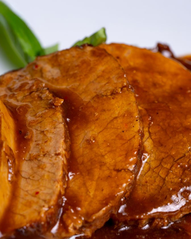Slices of tender roast leg of lamb served with pan gravy