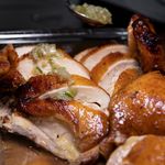 Sliced sous vide bone-in turkey breast with crisp golden skin