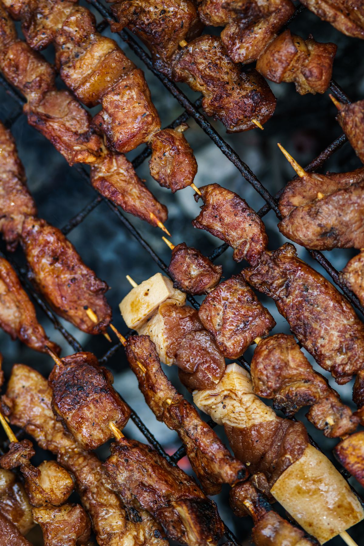 Beef and vegetable skewers charring over a hot grill