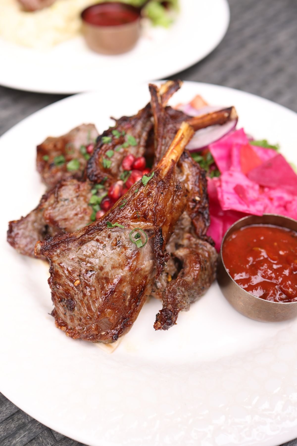 Grilled lamb loin chops served with sauce and cabbage