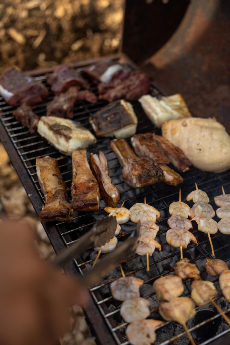 An assortment of meat cooking on a grill