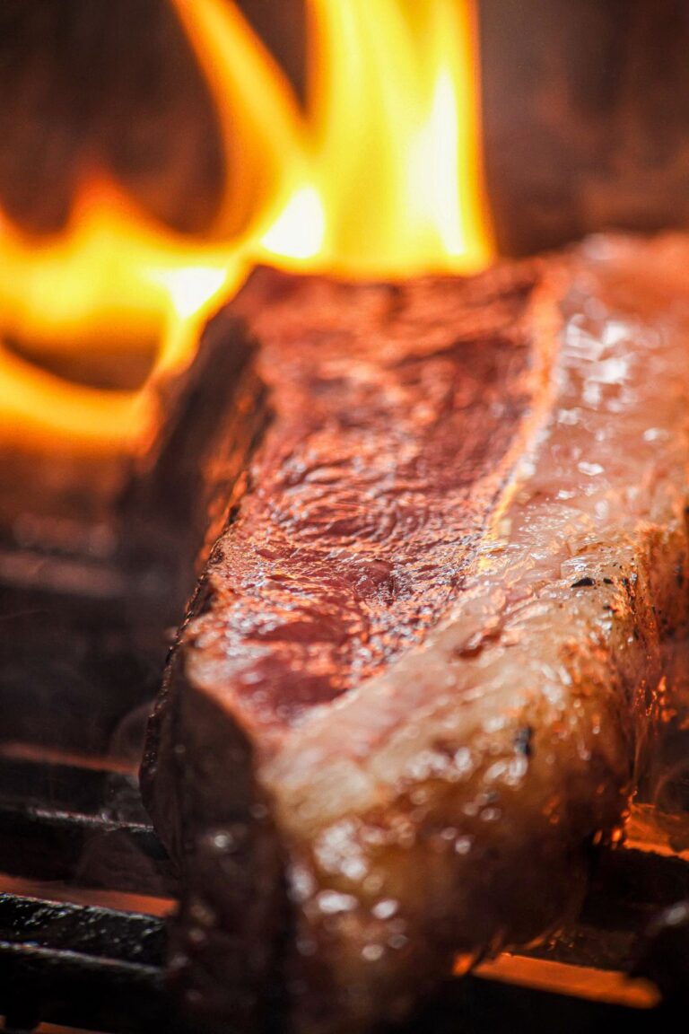 A close up of a steak developing a browned Maillard crust