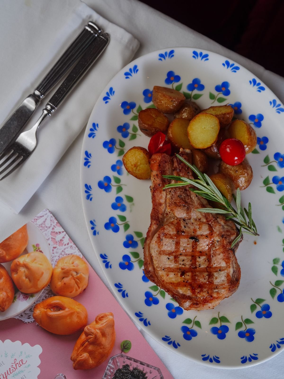 Golden pan seared pork chop with rosemary and roasted potatoes