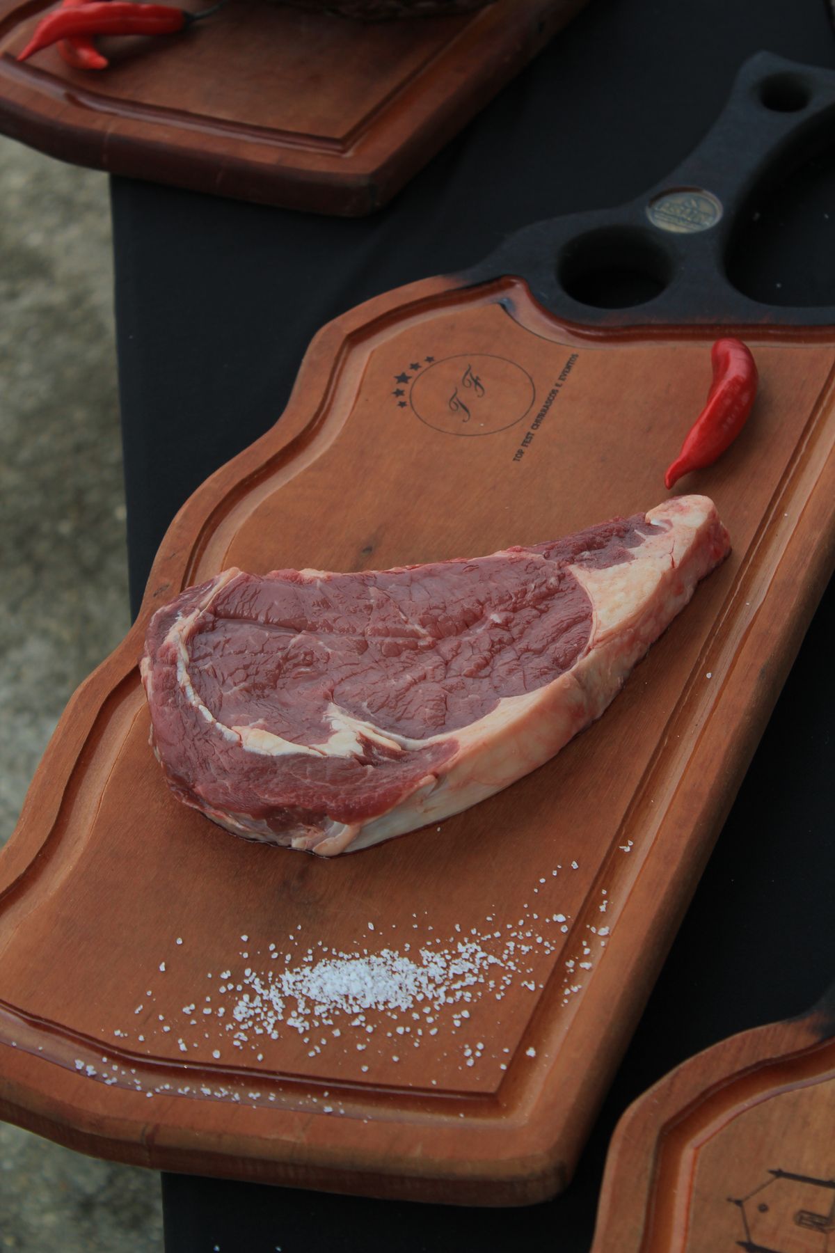 Raw ribeye steak on a wooden board before the water bath