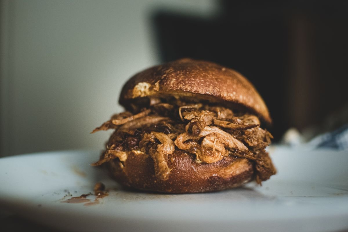 Shredded slow cooker pulled pork tossed in its own juices