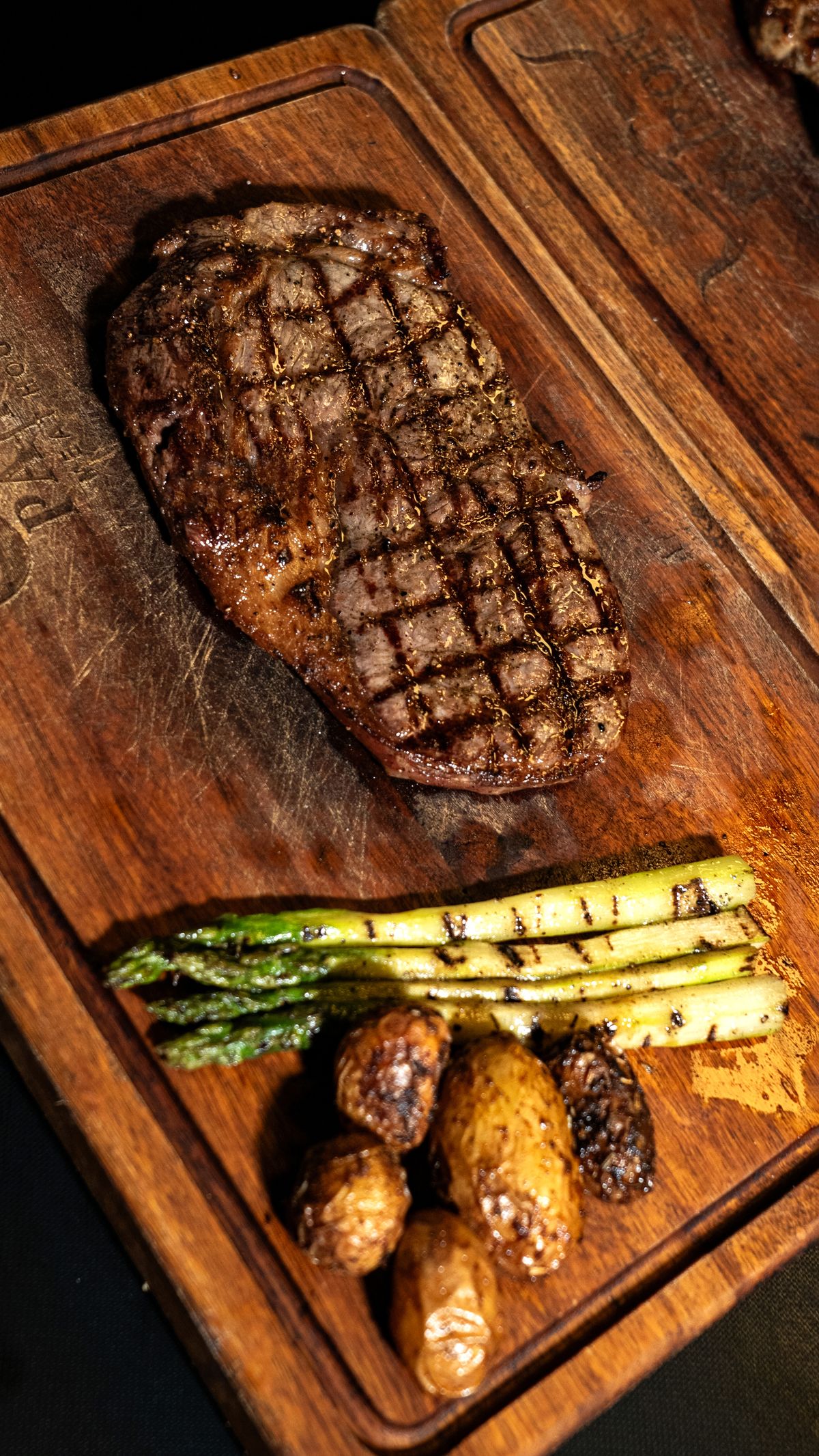 Sous vide hanger steak seared and sliced on a wooden board