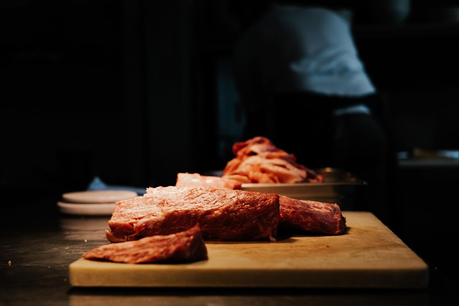 Top sirloin steak resting on a wooden cutting board before being sliced into strips for beef stroganoff