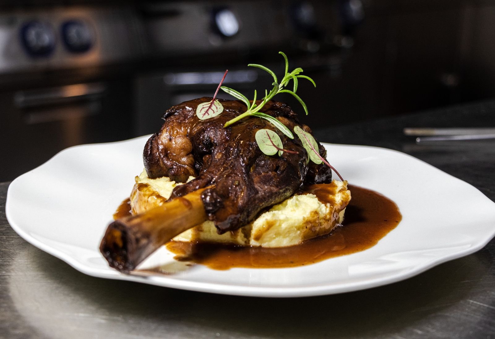 Braised lamb in a dark glossy miso sauce served over mashed potato