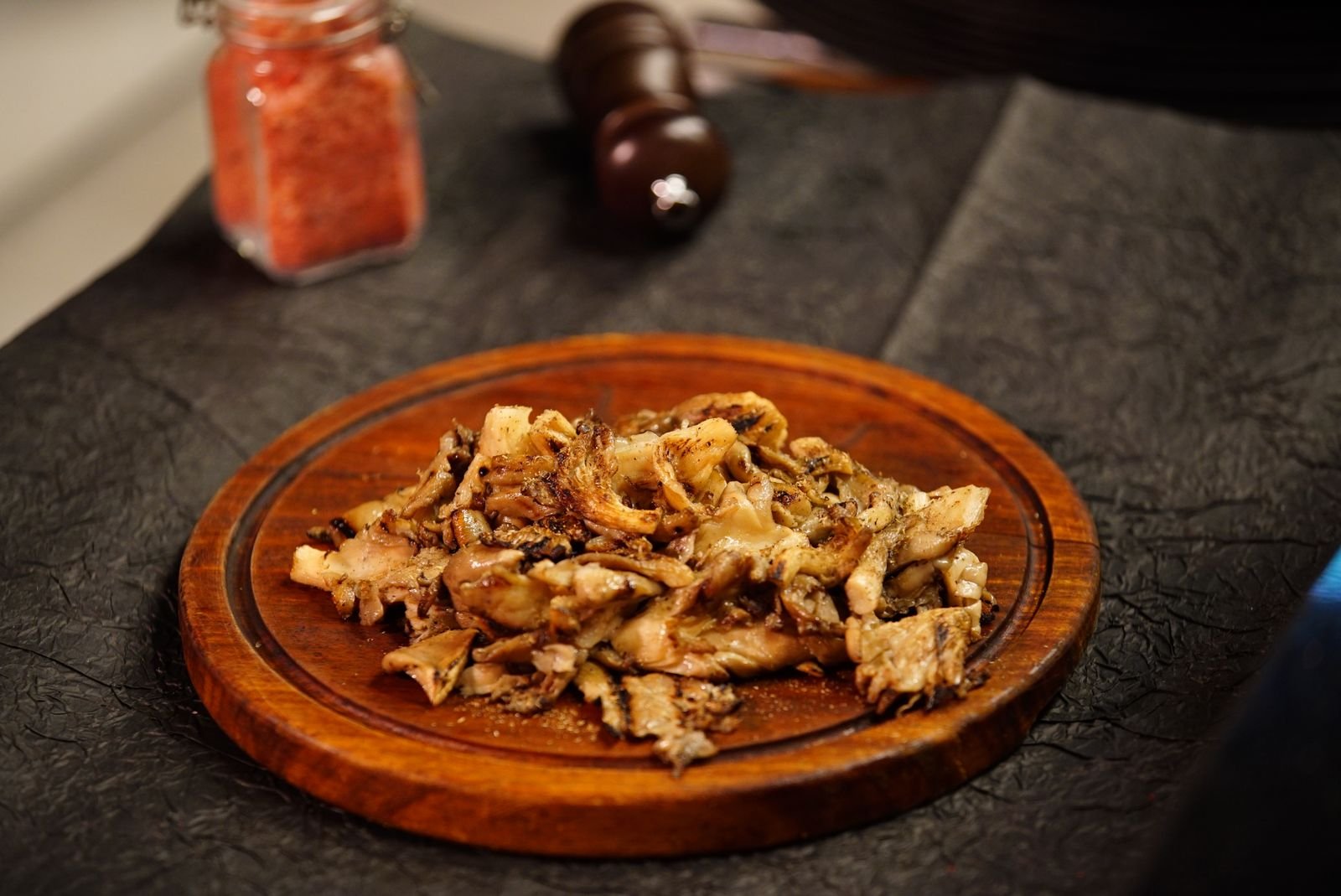 Brown oyster mushrooms on a wooden plate ready for a miso lamb braise