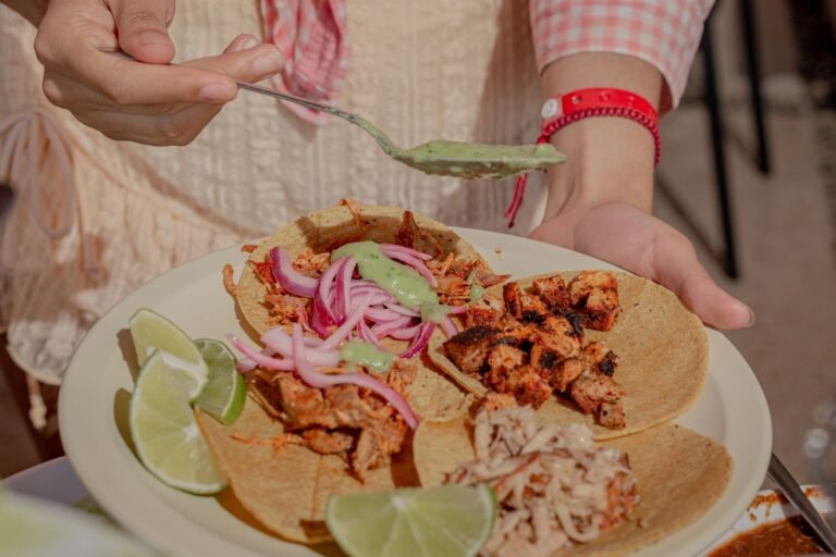 Crisp carnitas tacos topped with charred pineapple, pickled red onion and lime