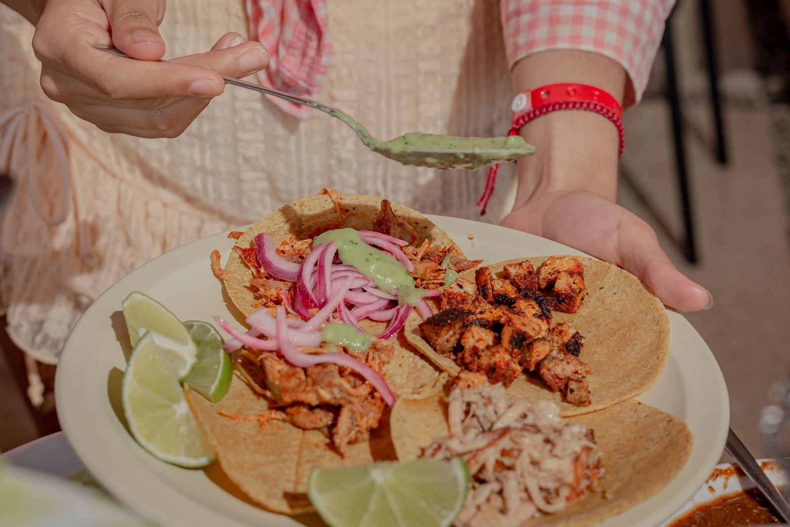 Crisp carnitas tacos topped with charred pineapple, pickled red onion and lime