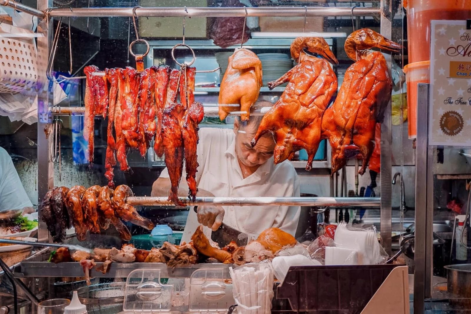 Glossy roasted pork hanging at a market stall in the char siu style