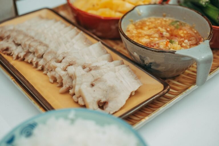 Sliced char siu pork with lacquered edges served over rice with pickled daikon