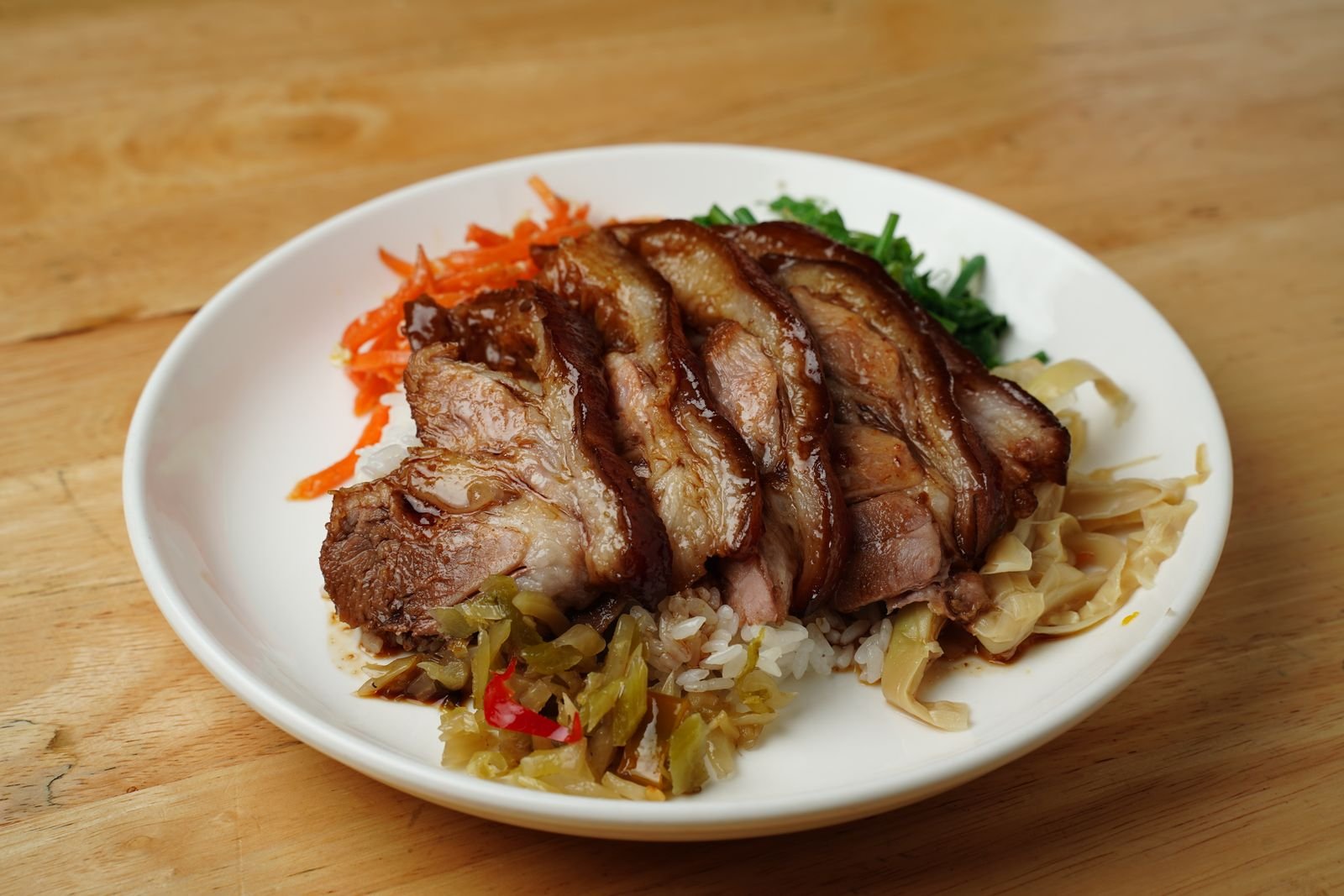 Sliced roast pork served with rice and quick pickled vegetables
