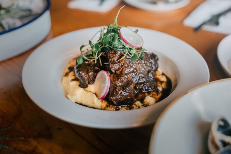 Coffee and cocoa braised beef chuck in a dark glossy sauce over mashed potatoes