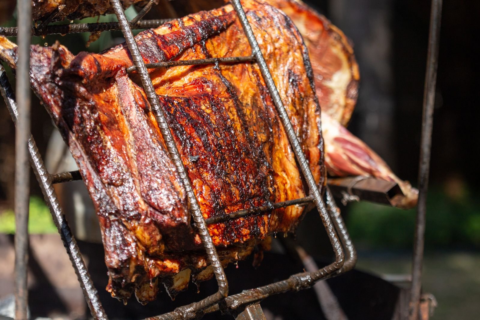 Pork crisping under high heat with browned edges and rendered fat
