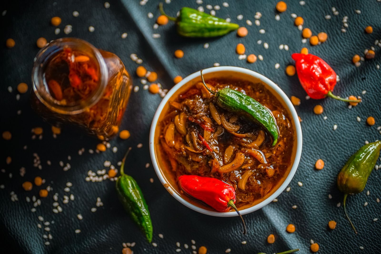 Quick pickled green chilies in a bowl with garlic and coriander seed