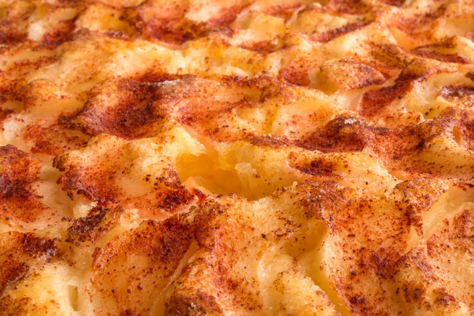 Golden browned mashed potato topping on a lamb and mushroom shepherds pie fresh from the oven