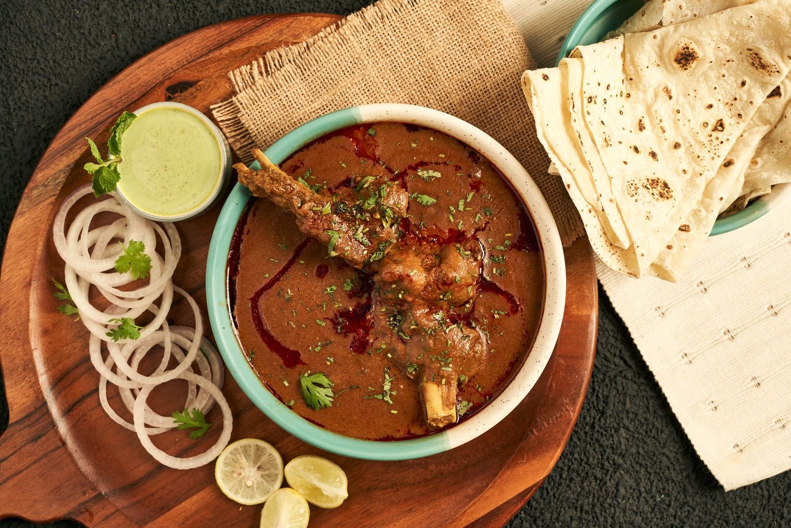 Lamb rogan josh served with flatbread and sliced raw onion