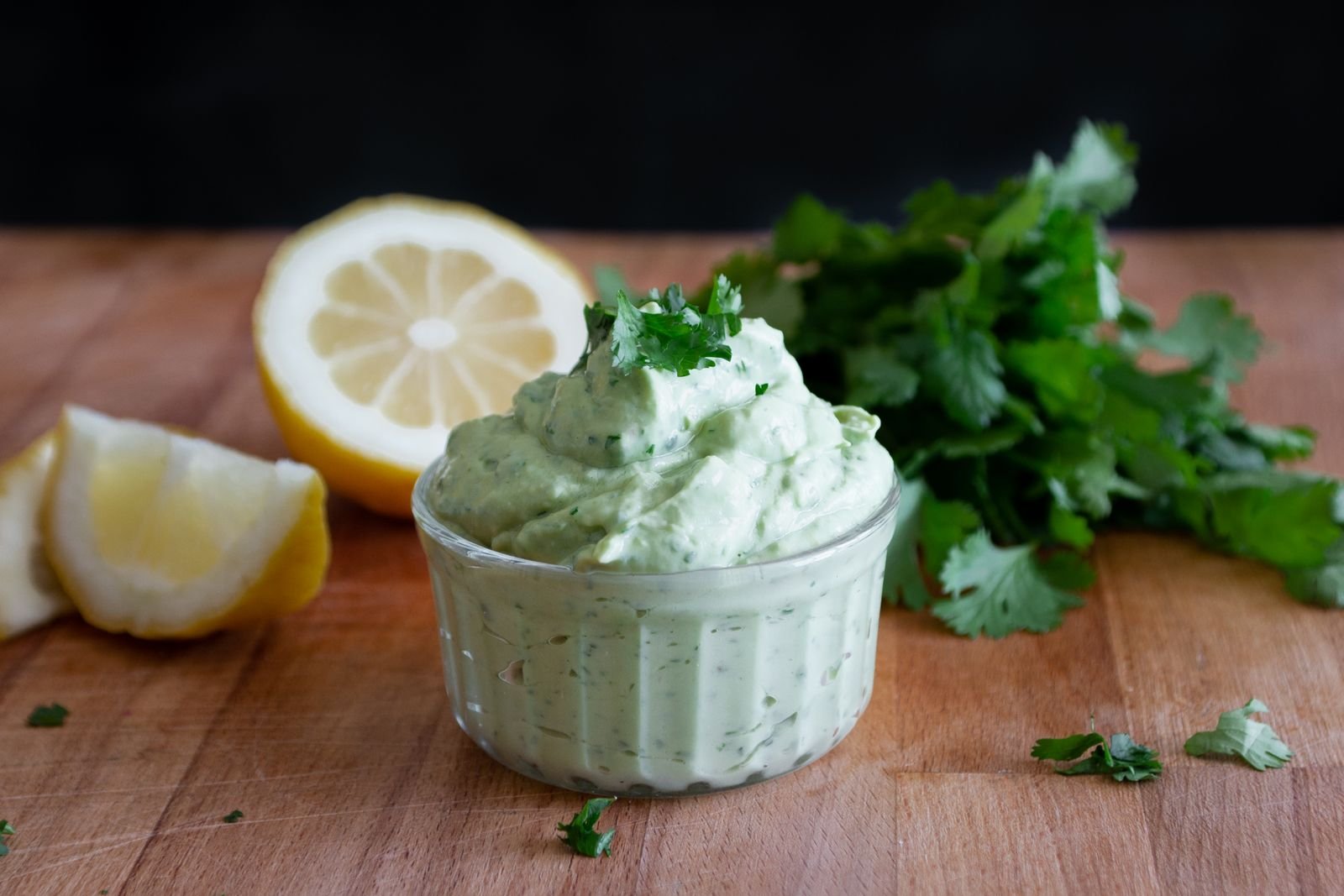 Bright green zhoug sauce of cilantro, green chili and garlic in a small bowl