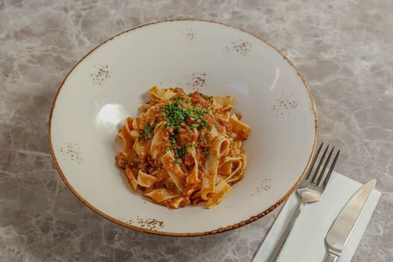 Slow cooked pork and porcini ragu tossed through pappardelle with grated Parmesan