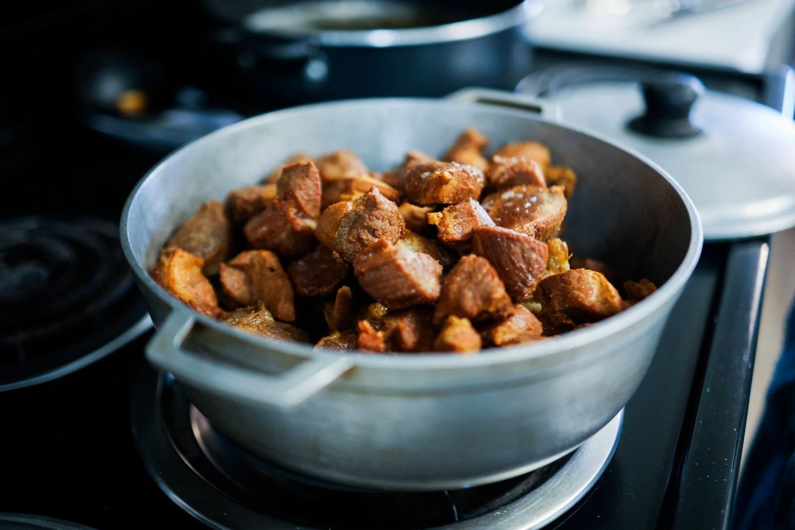Tender chunks of braised beef chuck in a heavy pot