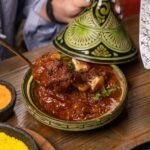 Moroccan lamb tagine with tender shoulder in a traditional conical pot