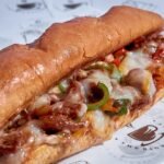 Philly cheesesteak on a soft hoagie roll with chopped beef, onions and melted cheese