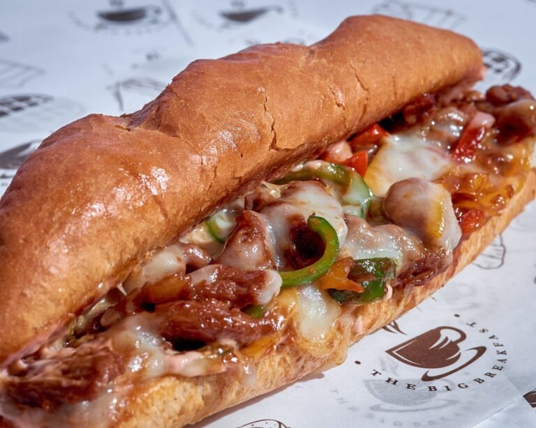 Philly cheesesteak on a soft hoagie roll with chopped beef, onions and melted cheese